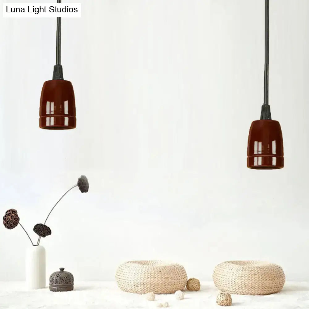 Two decorbites™ retro style mini hanging pendant lights with adjustable black cords and deep brown red ceramic ceiling shades