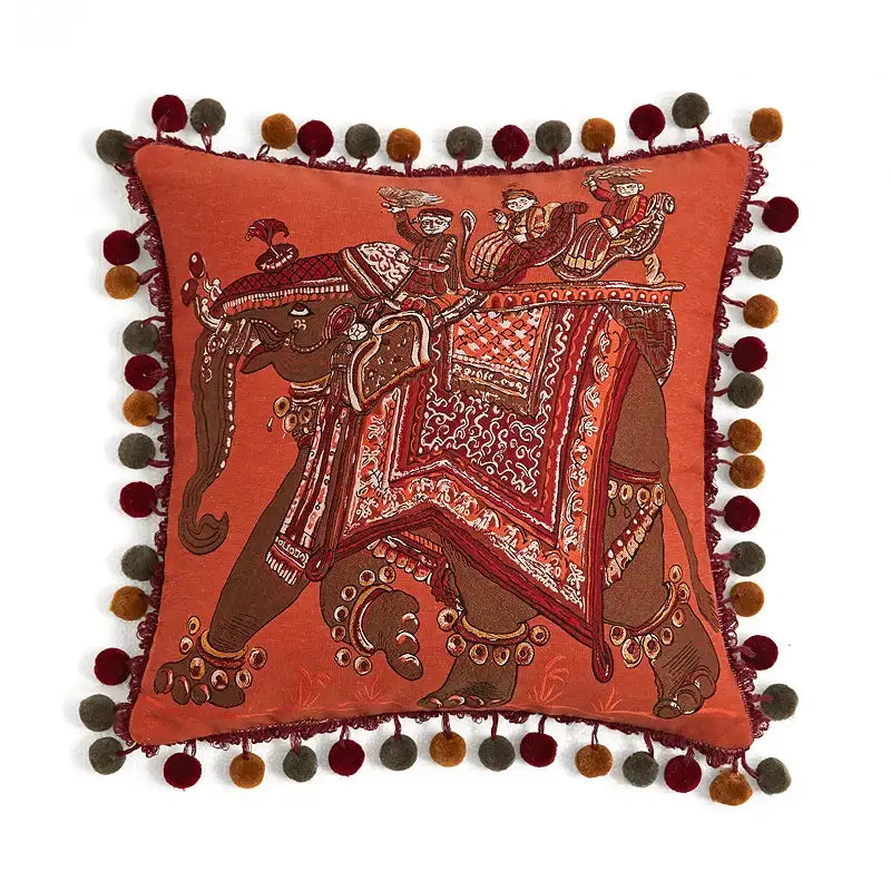 Orangish-red square cushion cover with embroidered elephant and multicolored pom-poms for decorbites american luxe retro decor