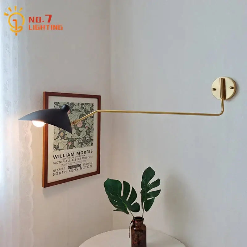 Gold-toned wall lamp with swing arm and matte black shade for bedroom reading light by decorbites copper swing