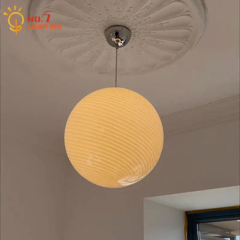 Warm-toned ribbed amber glass pendant light with chrome fixture designed for dining room glass pendant lights
