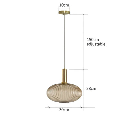 A modern pendant light with a gold-toned metal fixture and ribbed amber glass shade perfect for dining room decorbites colorful glass pendant lights