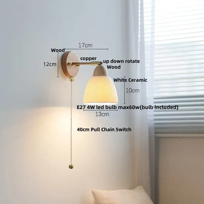 A warm-toned wall sconce light with ribbed white ceramic shade, wooden base, and copper arm for bedroom use