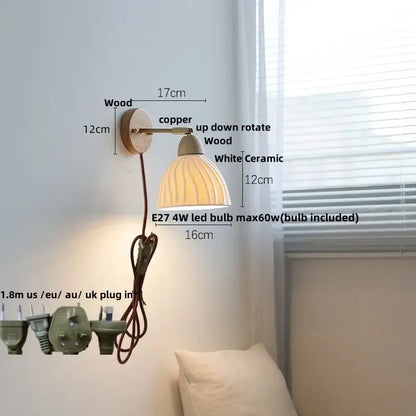 White ribbed ceramic and wood wall sconce light with fluted bell-shaped shade for bedroom use