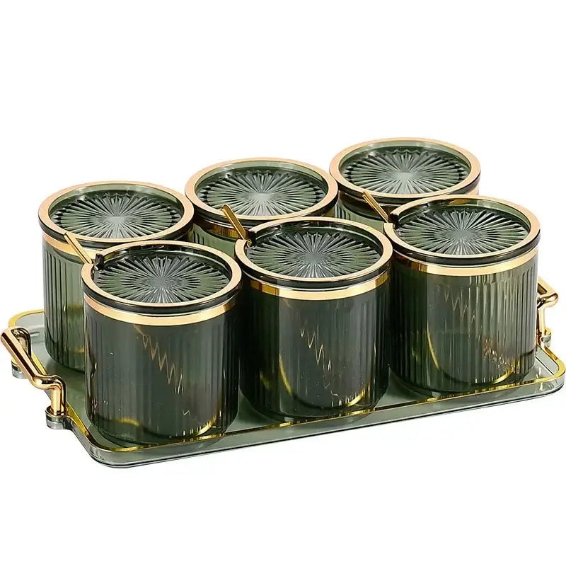 Set of six dark green decorbites acrylic seasoning jars with gold lids on matching tray for kitchen storage