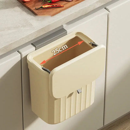 Cream-colored plastic kitchen cabinet hanging trash bin with hinged lid and vertical ribbed texture for decorbites kitchen cabinet