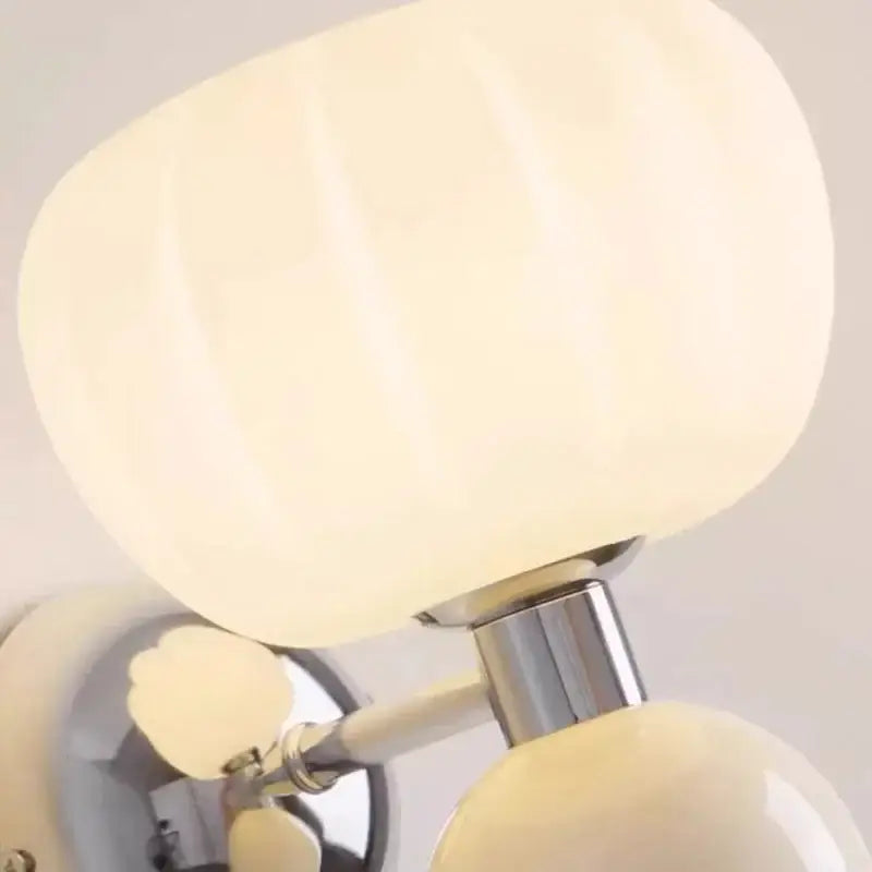 Cream breeze pumpkin wall lamps with ribbed cream-colored glossy glass shade and polished chrome stem for bedroom decorbites lighting