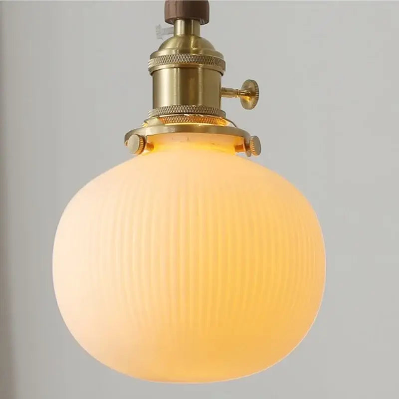 Warm-toned ribbed glass pendant lamp with brass socket and walnut ceramic led pendant for dining room decorbites ceramic led