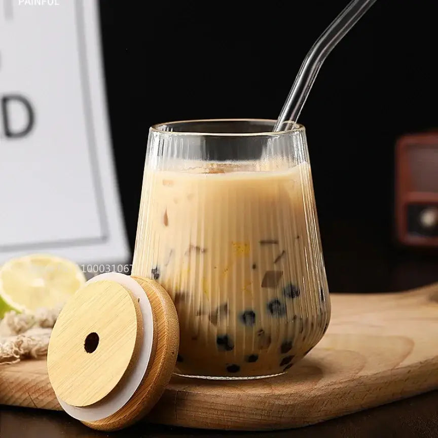 Clear ribbed glass cup from a glass cup set filled with iced coffee and black tapioca pearls for kitchen dining use
