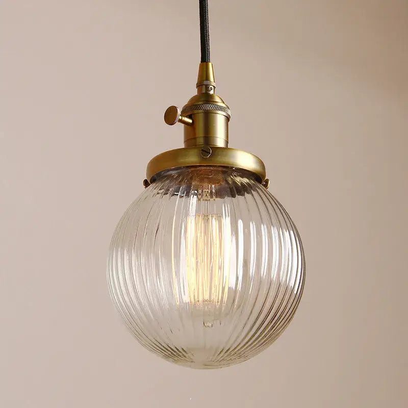 Vintage-style pendant light with a clear ribbed glass globe and brass fixture for living room decorbites clear glass globe