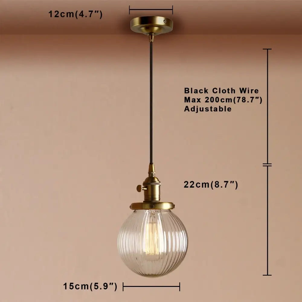 Vintage-style brass pendant light with ribbed glass globe and exposed filament bulb for living room decorbites clear glass