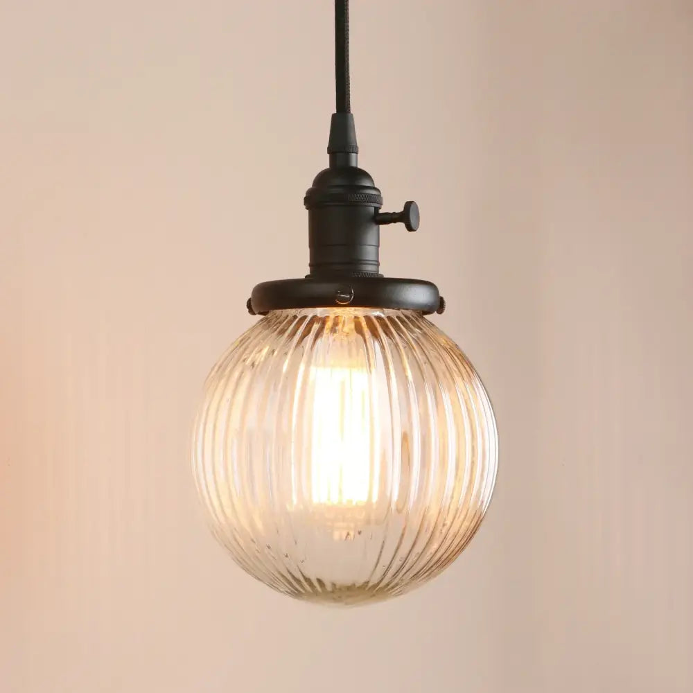 Warm-toned ribbed glass globe pendant light with black metal fixture for living room decorbites clear glass design