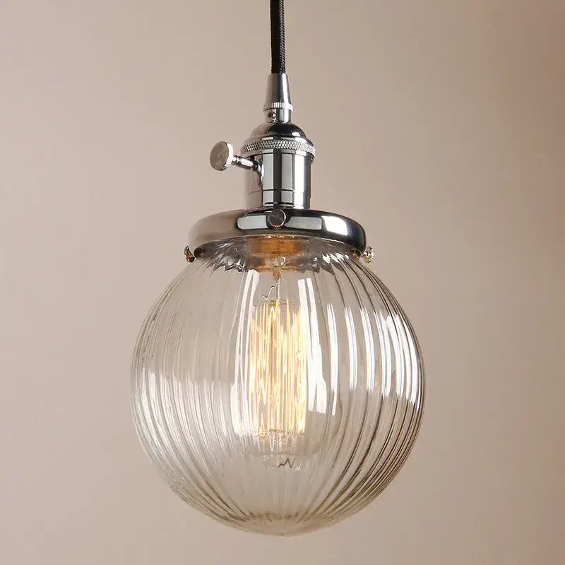 Ribbed glass globe pendant light with clear glass and chrome fixture featuring exposed filament bulb for living room decorbites