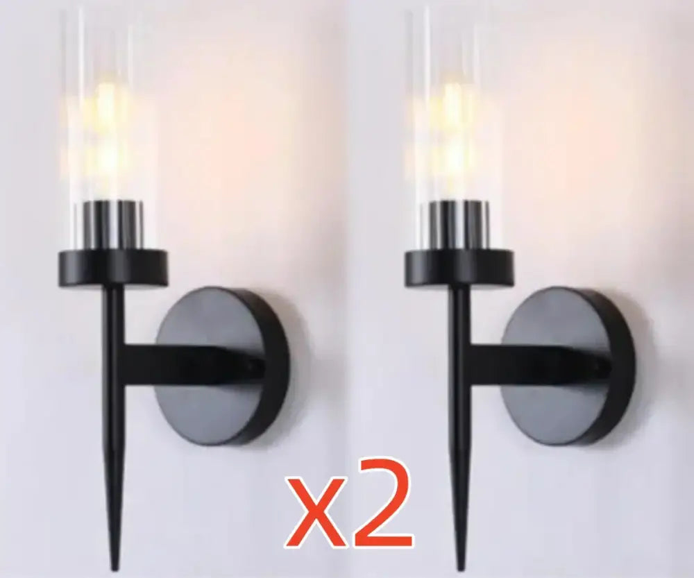Black modern wall sconce with cylindrical glass shade and sleek metal finish for decorbites gold led wall lights in bedroom