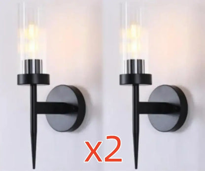 Black modern wall sconce with cylindrical glass shade and sleek metal finish for decorbites gold led wall lights in bedroom