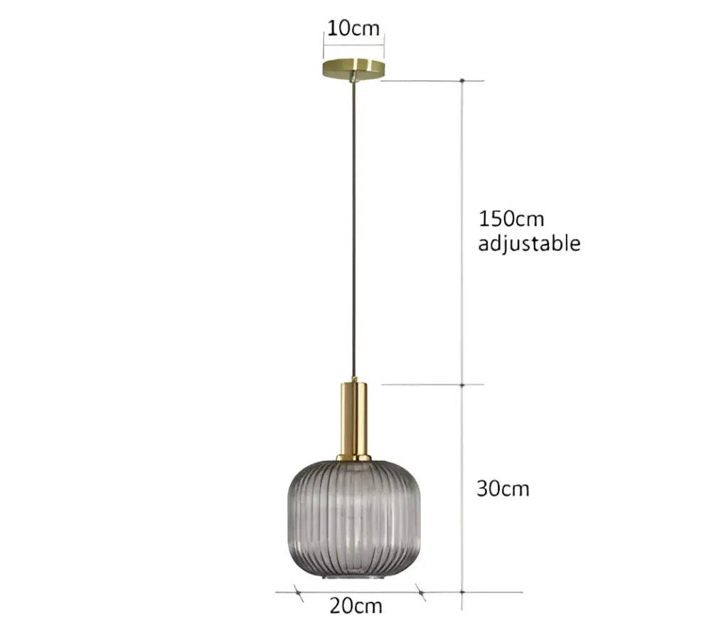 A modern ribbed glass pendant light in translucent gray with brass accents ideal for dining room use
