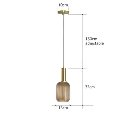 A modern ribbed glass pendant light with an amber textured glass shade and gold-toned metal fixture for dining rooms