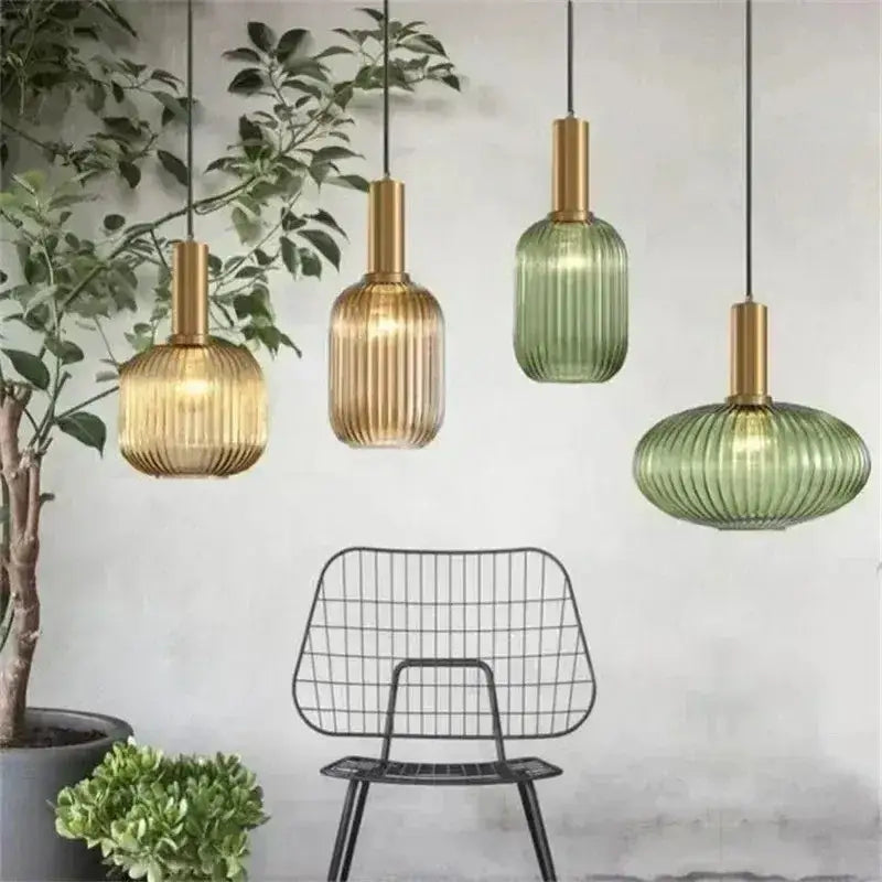 Set of ribbed glass pendant lights in amber and sage green with brushed brass finish for dining room lighting
