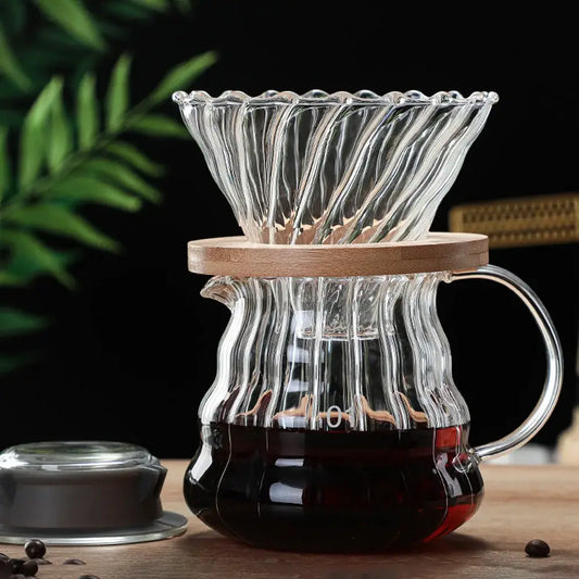 Clear glass ribbed coffee maker pot with fluted design and wooden lid for precise coffee brewing in the kitchen