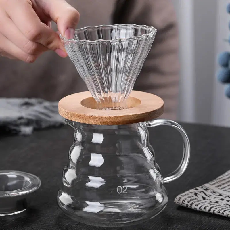 Clear glass ribbed coffee maker pot with fluted cone filter and wooden lid for pour over coffee brewing