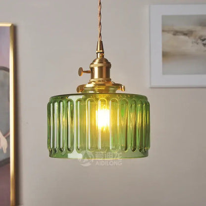 Ribbed green glass pendant light with brass hardware featuring a ribbed glass pendant light design for bedroom use