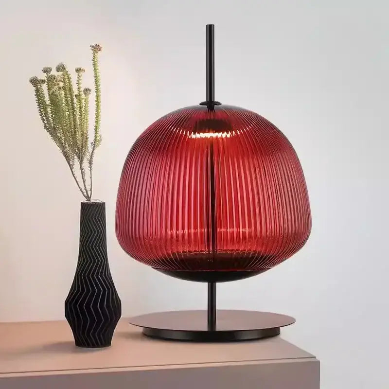 A striking red ribbed glass table lamp with sleek black metal base for decorbites green red bedroom lighting