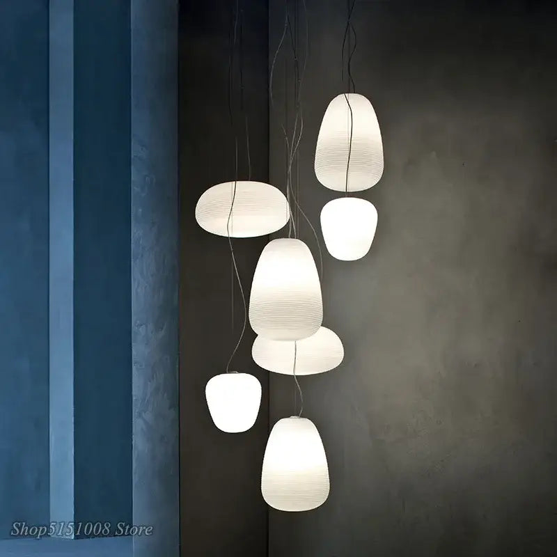 Modern white paper pendant light with ribbed off white glass whorl design for minimalist kitchen decor