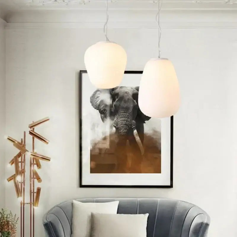 Two off-white ribbed glass cocoon pendant lights hanging as kitchen decorbites glass cocoon pendant lamps
