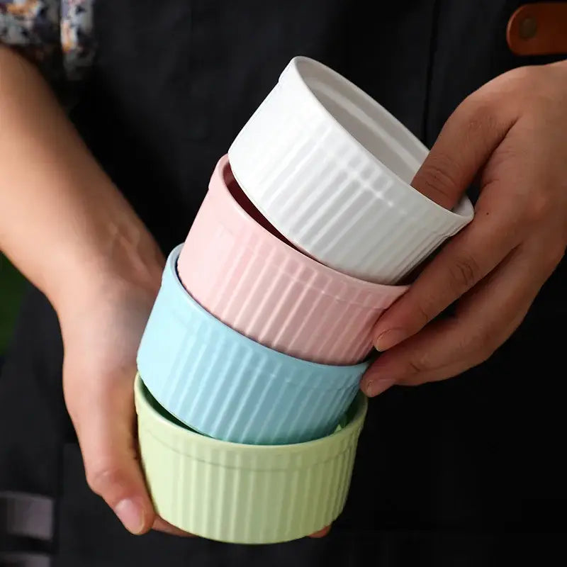 Stack of pastel-colored decorbites ceramic dessert bowls with ribbed texture in white pink blue and mint green