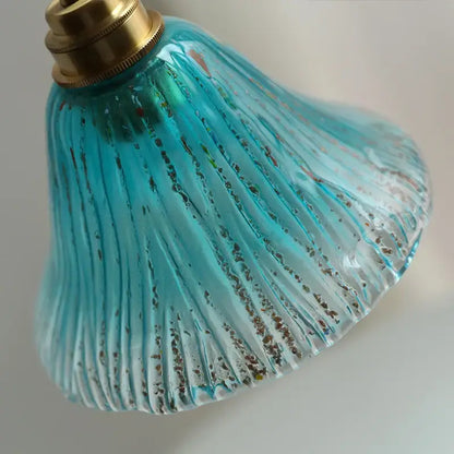 Ribbed teal blue glass led pendant light with vertical ridges and gold flecks featuring a brass fixture for dining room decorbites blue glass