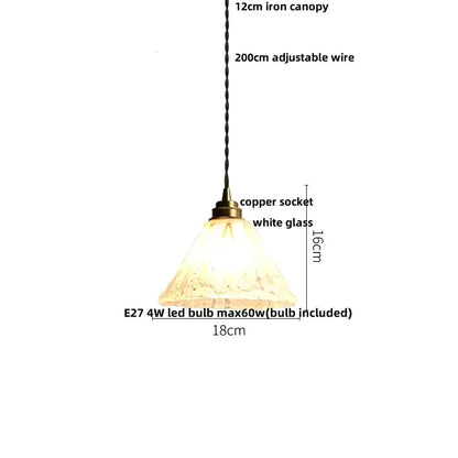 A warm glowing pendant light with textured white glass shade 18cm diameter and twisted black wire from iron canopy