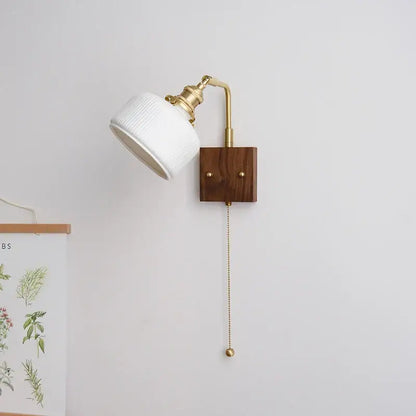 Ribbed white ceramic and copper led wall lamp with brass arm and wooden base featuring pull-chain switch for bedroom mirror light