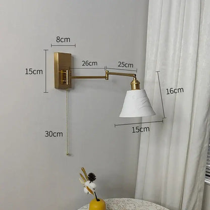 Gold-finished adjustable wall sconce with white marble-effect shade decorbites brass swing arm bedroom light