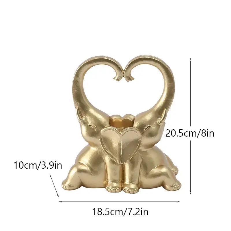 Golden resin decorbites elephant couple candlestick with elephants forming a heart holding a smaller heart decor piece