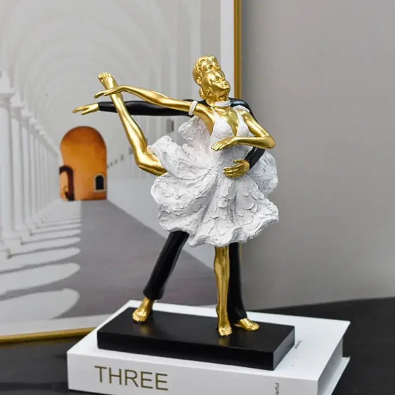 Golden and white ballet dancer figurine with intricate detailing on black base for decorbites dancing couple sculpture
