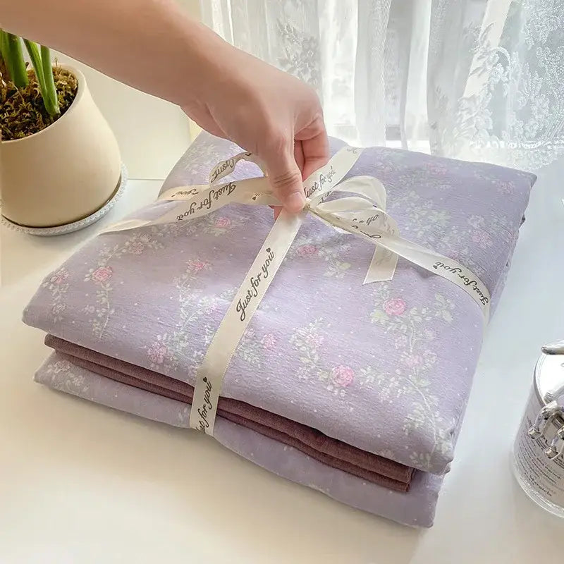 Romantic pink cotton flower print bedding set with lavender floral-patterned cotton sheet tied with cream ribbon just for you
