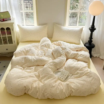 Romantic pink cotton flower print bedding set with cream plush quilt featuring subtle black polka dots and soft texture