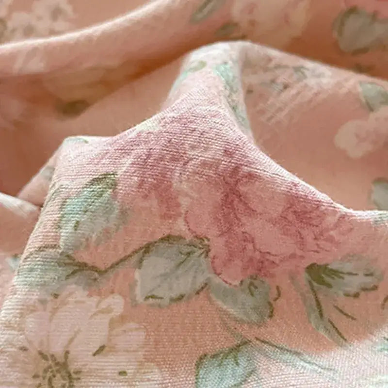 Romantic pink cotton flower print bedding set with soft pink fabric and delicate muted green and beige floral patterns