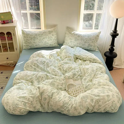 Soft cream-colored duvet with delicate green cotton flower print embroidery and matching pillowcases on light blue decorbites bedding set