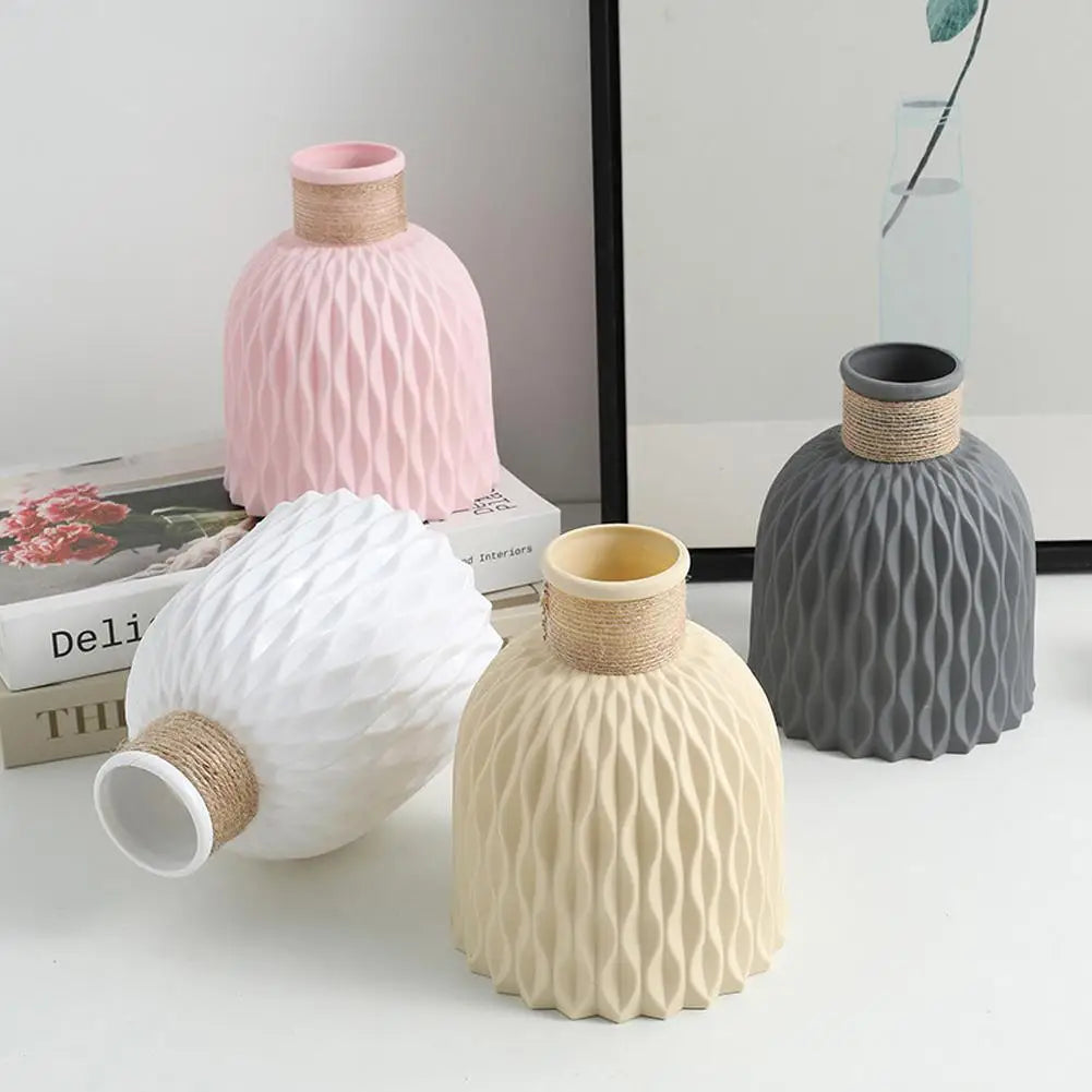 Pastel pink ceramic rope plastic vase with textured wavy surface and twine-wrapped neck for home decoration