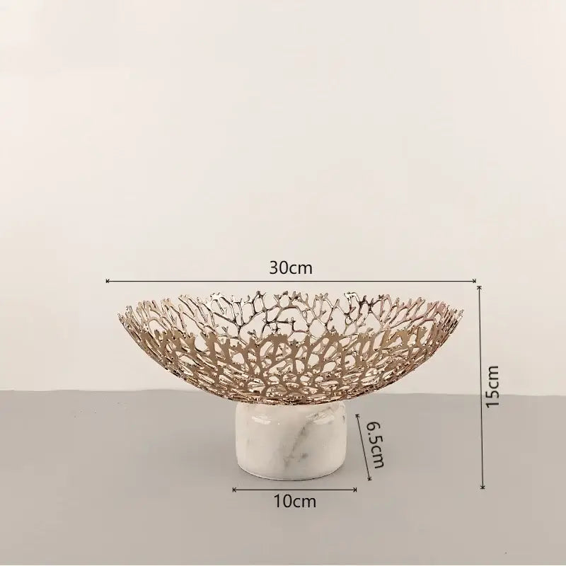 A rose gold decorbites coral disc pedestal fruit bowl with intricate lace design on white marble base for dining decor