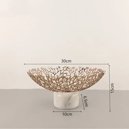 A rose gold decorbites coral disc pedestal fruit bowl with intricate lace design on white marble base for dining decor