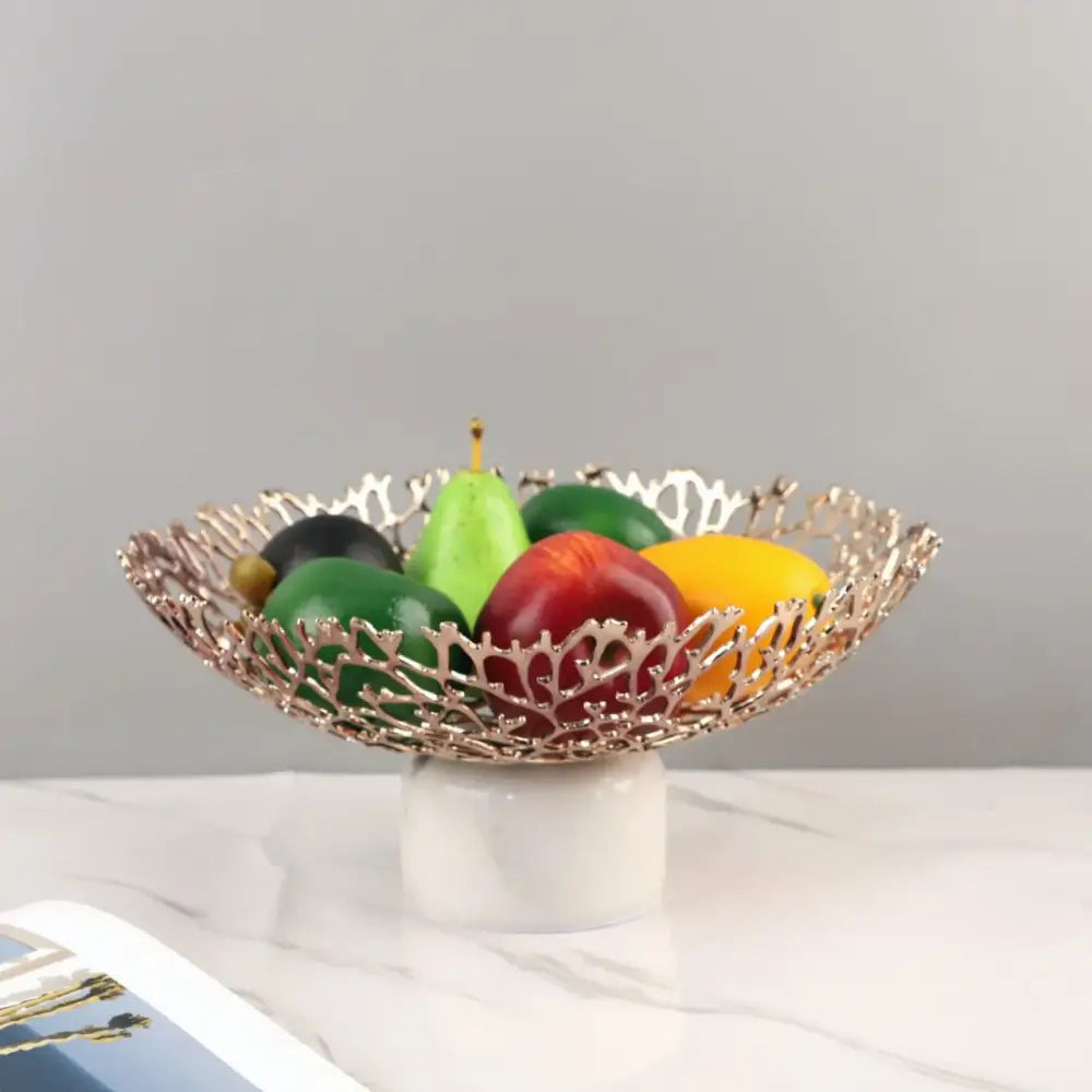Rose gold coral disc pedestal fruit bowl with intricate lace-like design on white marble for elegant dining decorbites coral disc