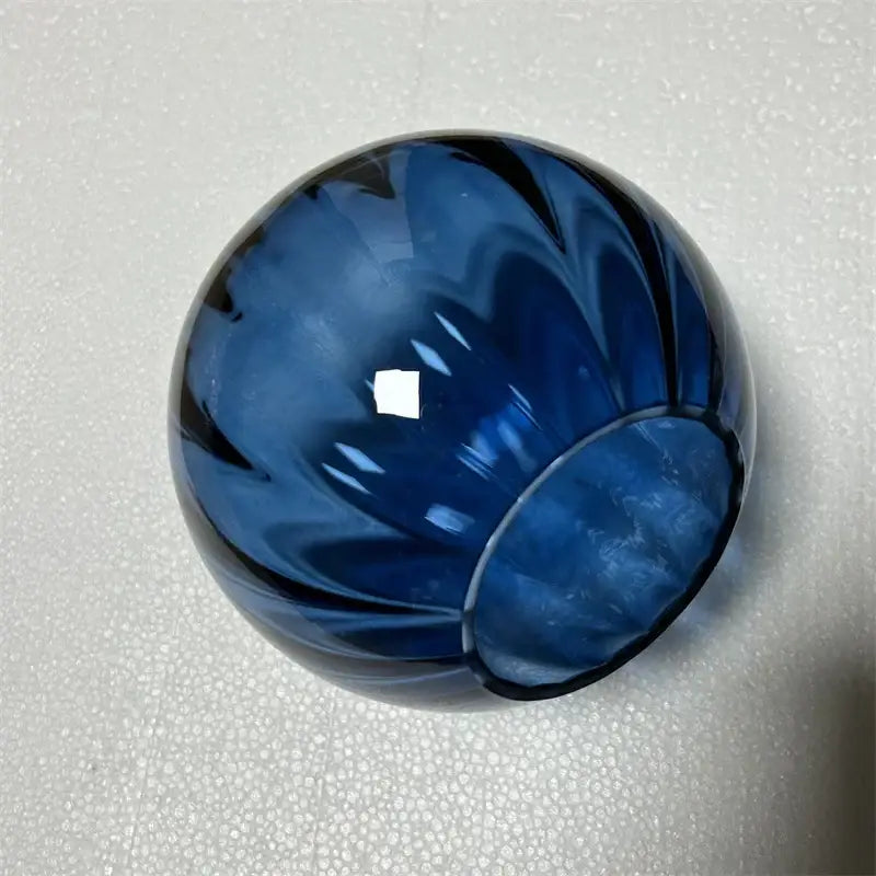 Deep blue glass ball pendant lamp with swirling black patterns and fluted rim for elegant decorbites glass ball decor