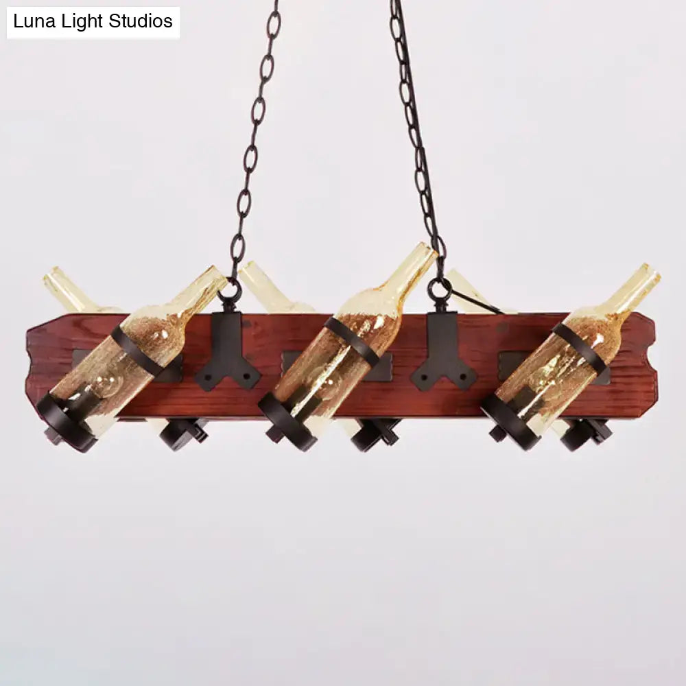 Rustic island lamp with brown wood arm featuring frosted white and amber glass wine bottle lights suspended by black metal chains