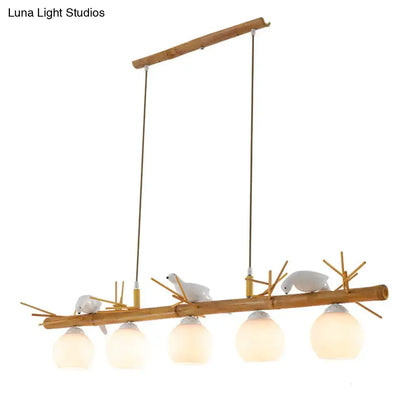 Decorbites modern cream glass wood pendant light with white bird deco on a dome island wood branch light fixture
