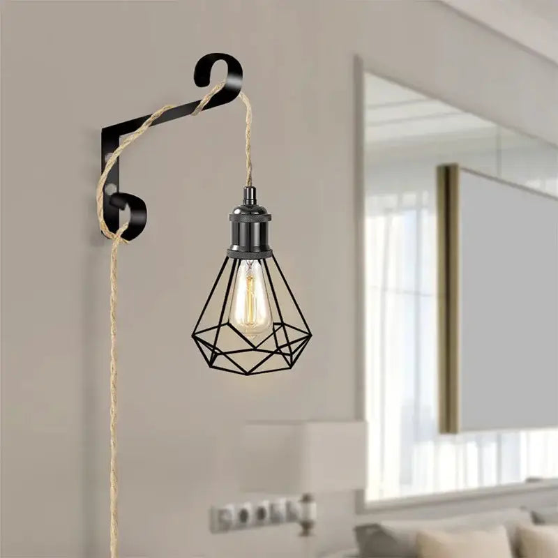 Rustic beige and black pendant light with geometric metal cage, edison bulb, and natural hemp rope light cord for living room
