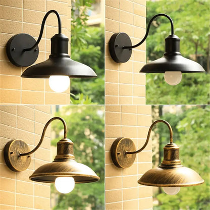 Rustic black gooseneck light fixture with black and antique brass curved arms and dome-shaped shades by decorbites black rustic
