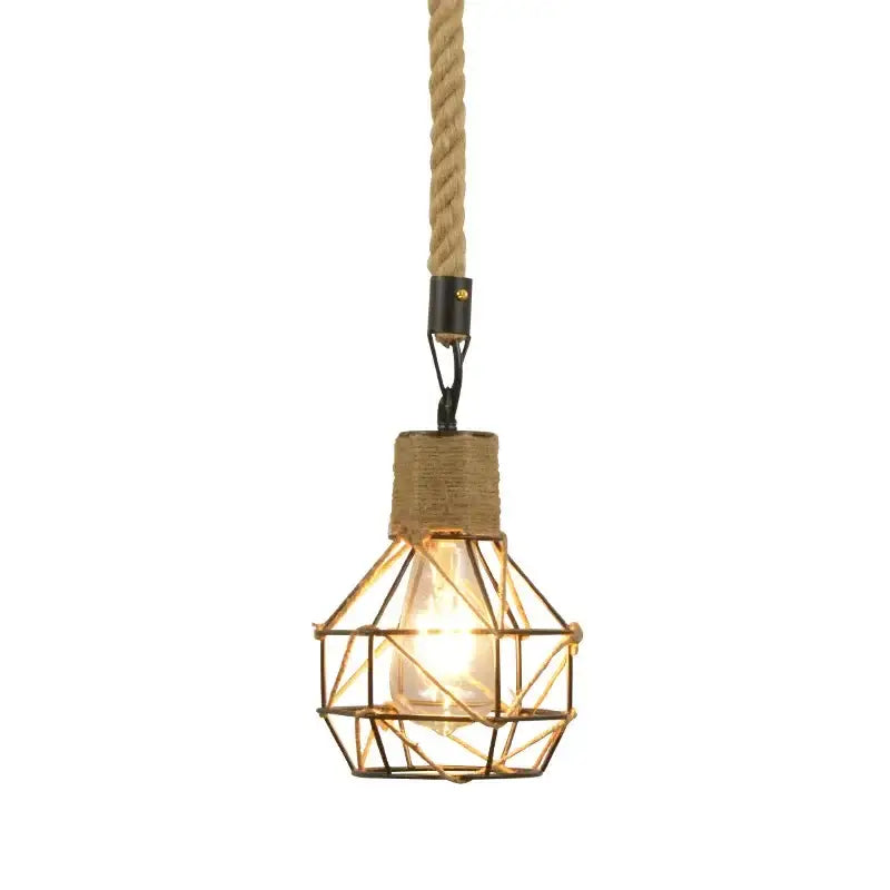 Rustic black iron pendant light with warm geometric wire cage, hemp rope suspension, and natural twine-wrapped base