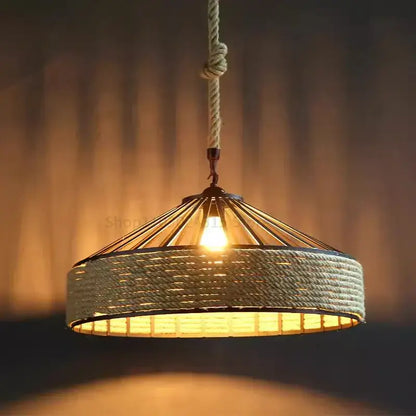 Rustic black iron pendant light with warm-toned woven rope-inspired detailing and braided cord pendant for kitchen use