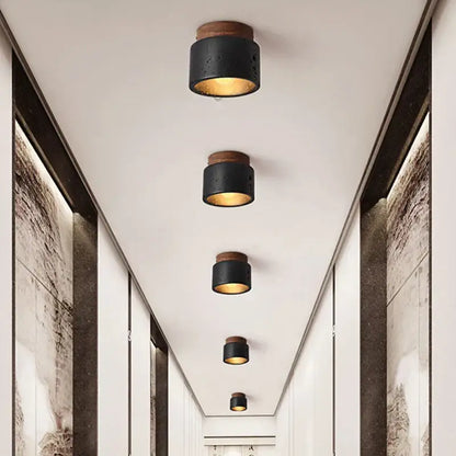 Rustic black travertine ceiling light with wooden top and warm golden interior glow for entrance hallway decorbites black travertine
